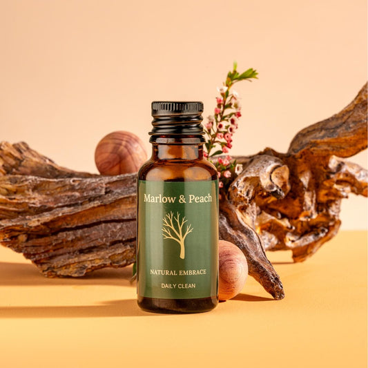 Bottle of Marlow & Peach natural product with decorative elements on a beige background